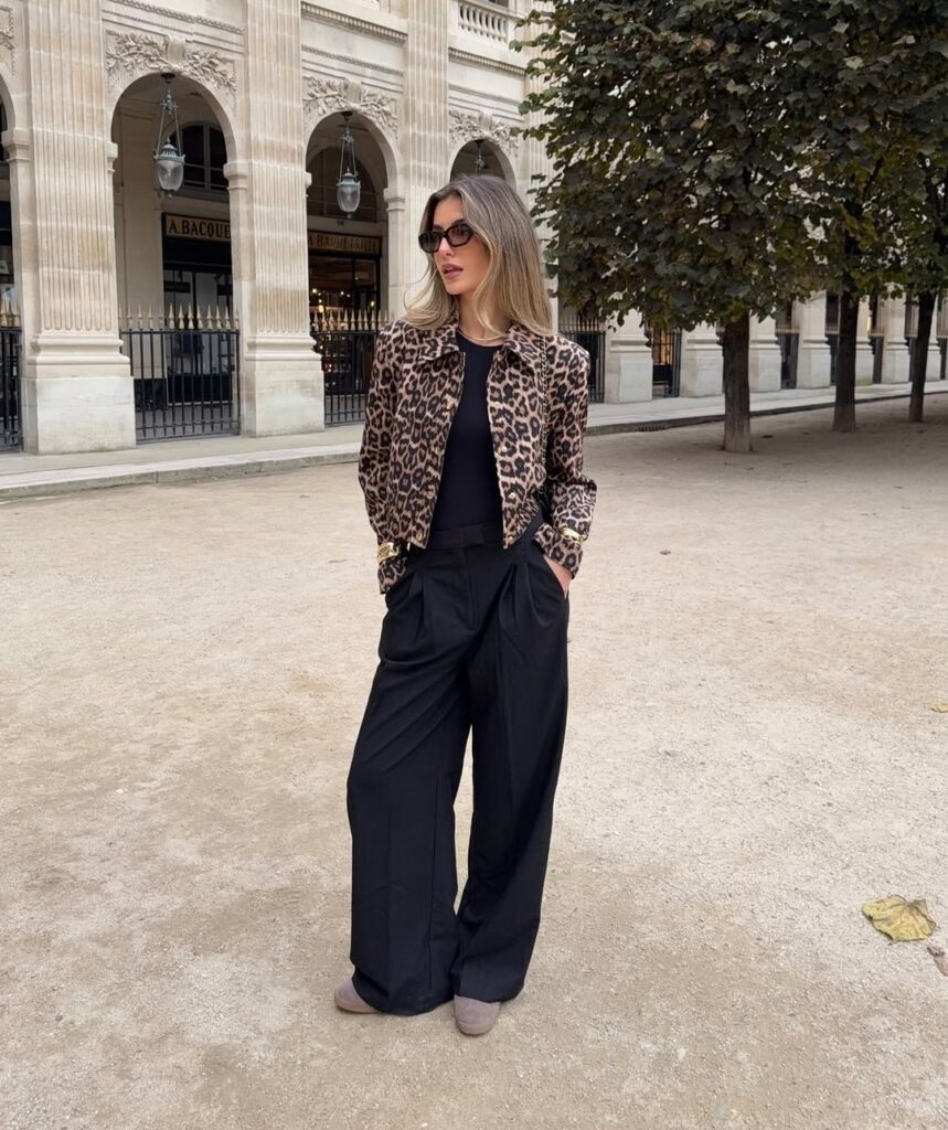 Classy fall outfit with leopard print jacket, black wide-leg trousers, and neutral boots