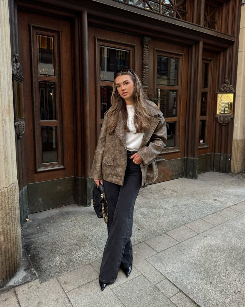 Chic fall outfit with grey suede jacket, white tee, black flare pants, and pointed heels