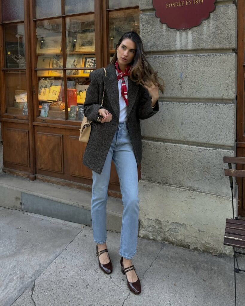 Fall outfit with grey coat, red silk scarf, light blue jeans, and burgundy shoes