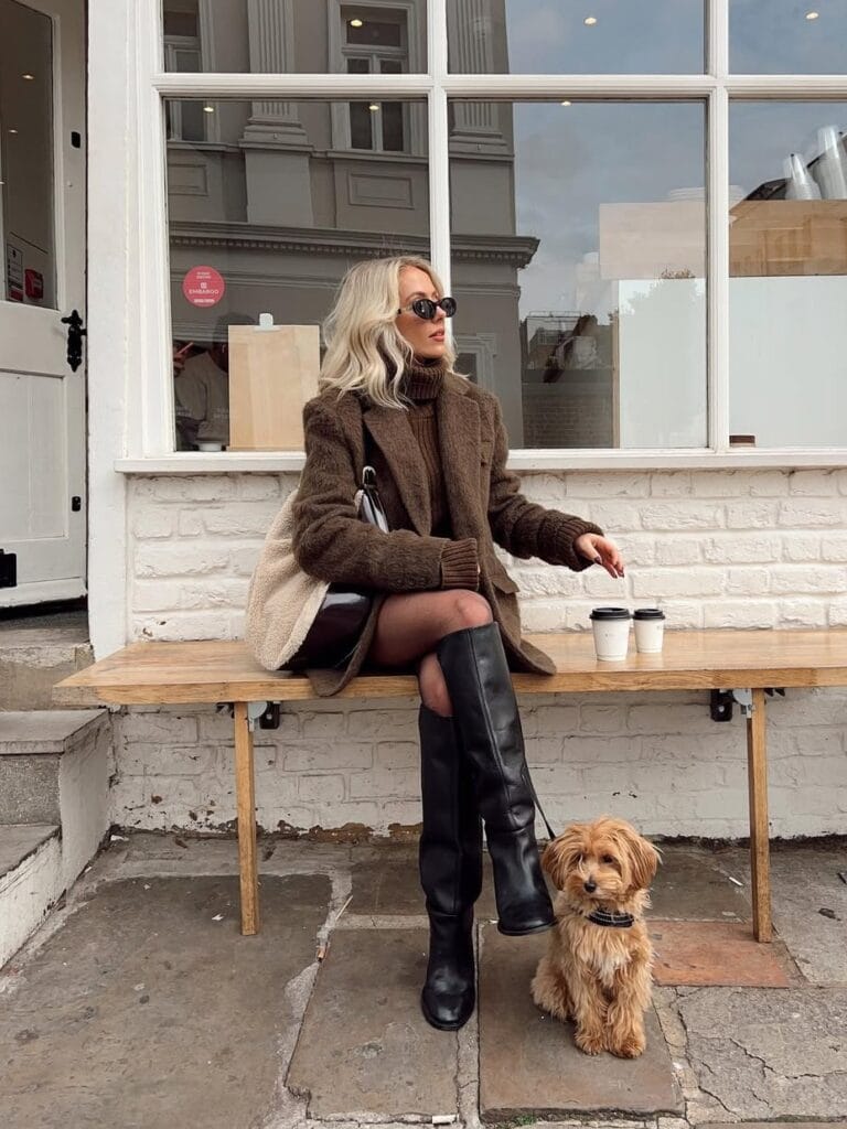 Classy fall outfit with brown fuzzy coat, matching turtleneck, and black knee-high boots