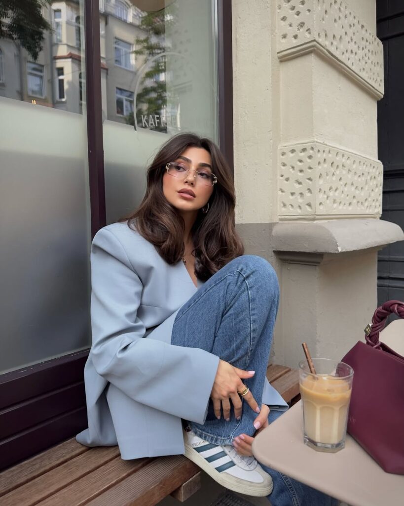 Fall outfit with powder blue oversized blazer, jeans, and white sneakers