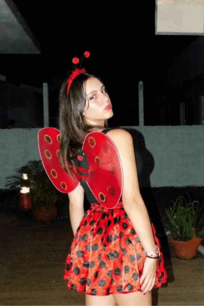 Halloween costume with red ladybug wings, black spots, and cute antennae, perfect for a playful and stylish Halloween party look.
