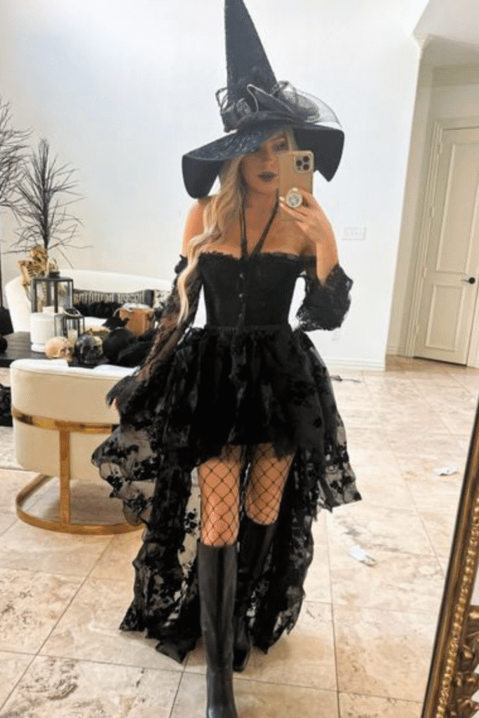 Glam witch Halloween costume with black lace dress, tall hat, and boots—a stylish take on the classic witch costume for Halloween.