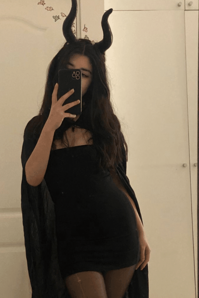 Maleficent Halloween costume with sculpted black horns and black dress, a glam and gothic villain look for Halloween parties.
