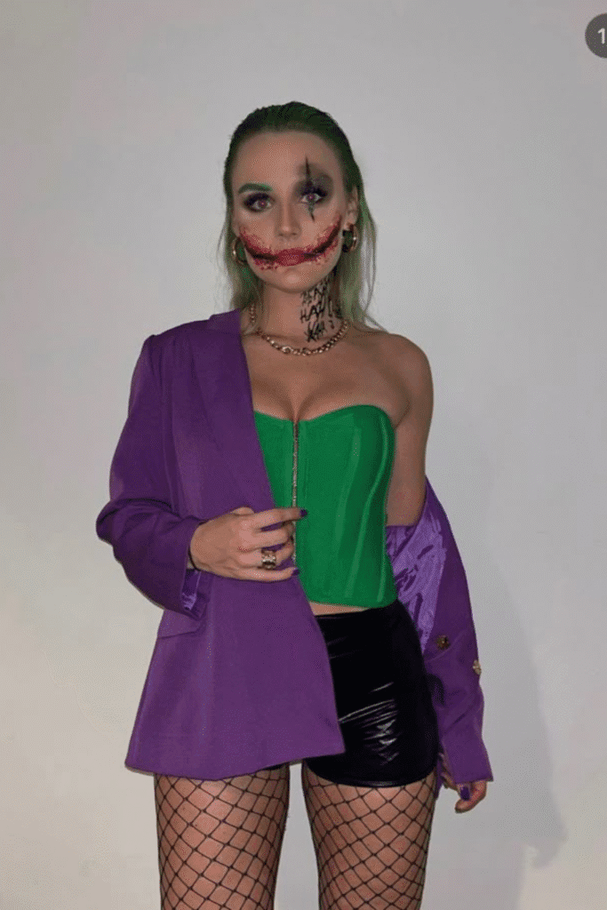 Female Joker Halloween costume with green corset, purple blazer, and dramatic makeup for a bold, fun Halloween party look.