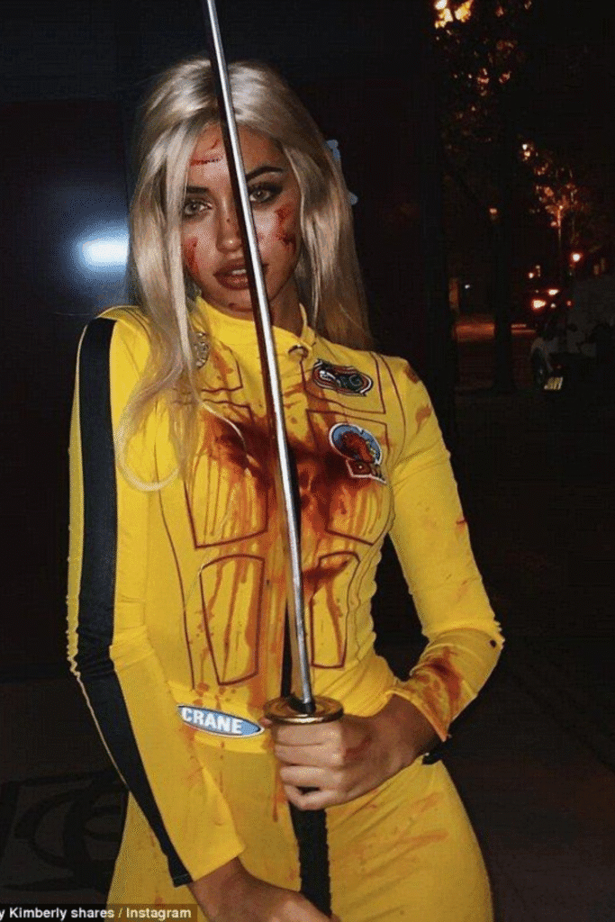 Kill Bill Halloween costume with yellow jumpsuit, sword, and blonde wig—The Bride look, bold and instantly recognizable for Halloween.