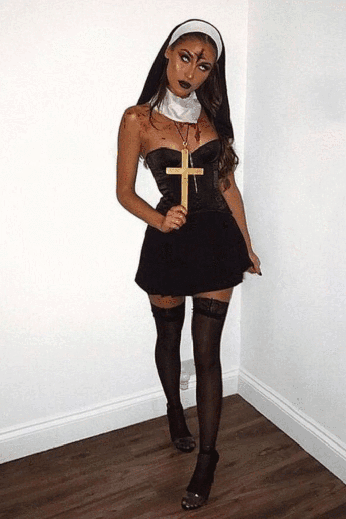 Dark nun Halloween costume with black corset, cross necklace, and dramatic makeup—a spooky and sultry party look.