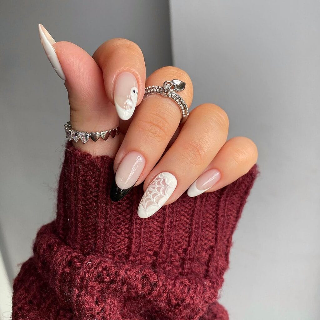 White Halloween nails with 3D spiderweb, black tip, and cute ghost accent on almond shape.