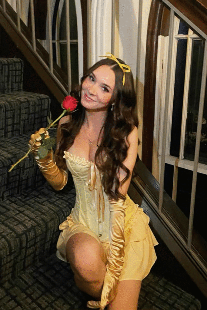 Belle Halloween costume with gold corset dress, gloves, and red rose—a Beauty and the Beast princess party look.
