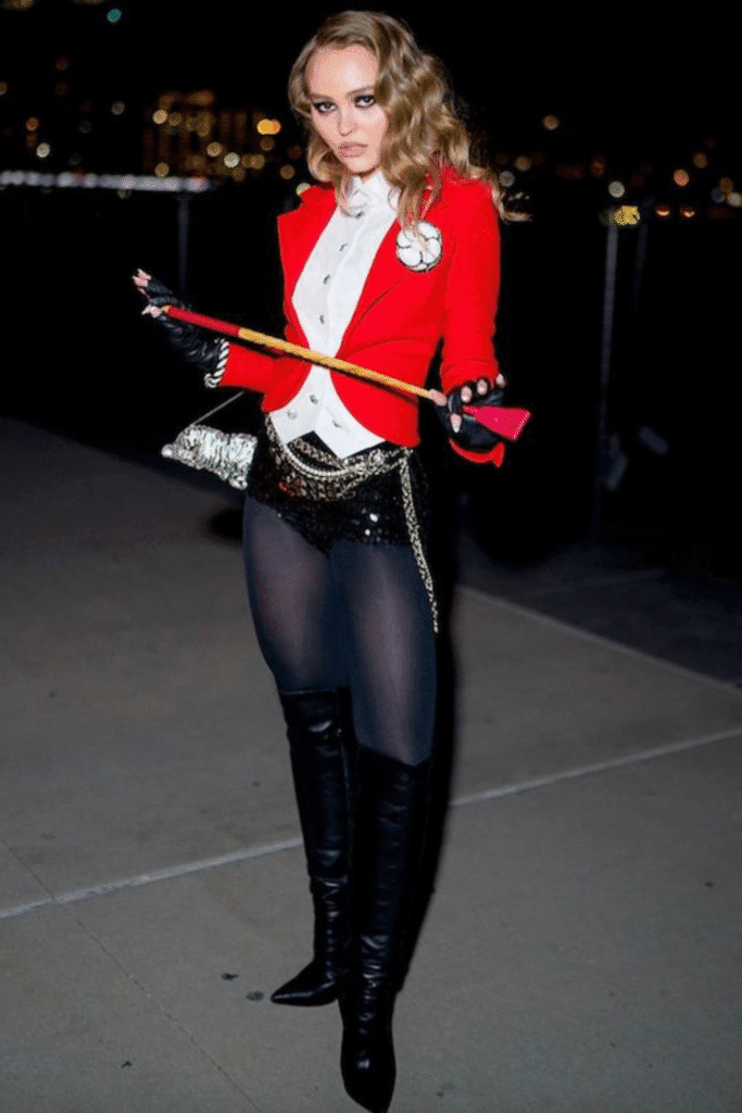 Circus ringmaster Halloween costume with red jacket, white vest, black shorts, and boots—a bold party look.