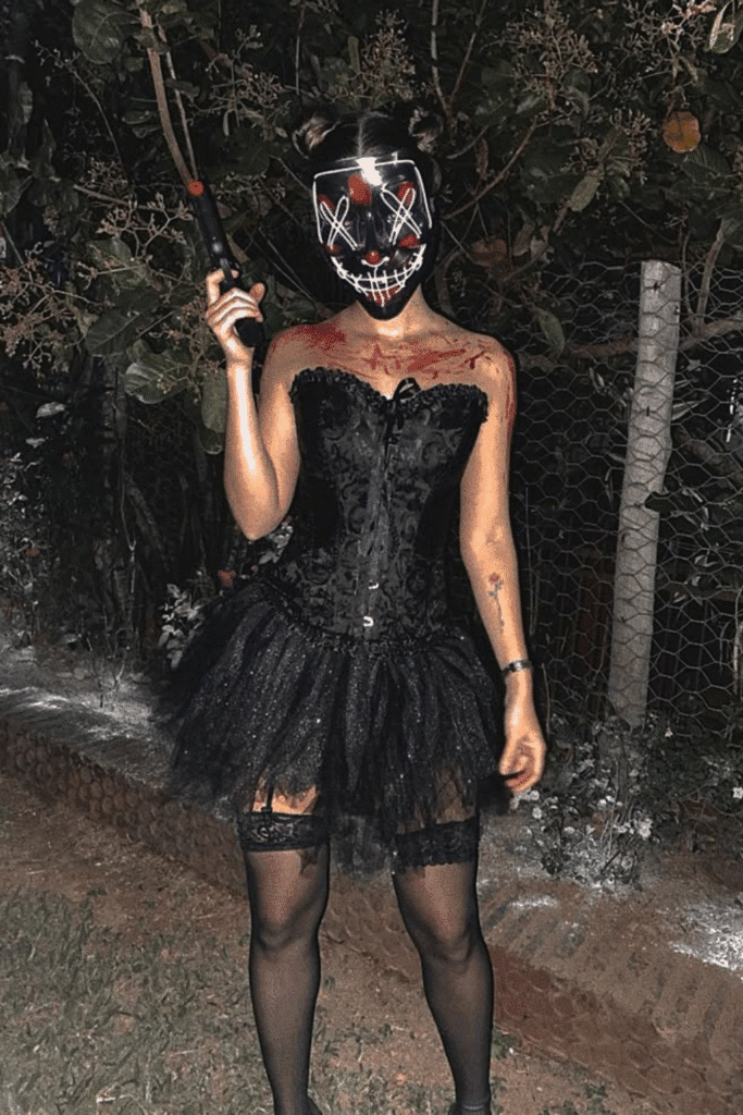 Edgy Halloween costume with black corset, tutu, and neon purge mask, a spooky yet stylish look for a bold Halloween party outfit.