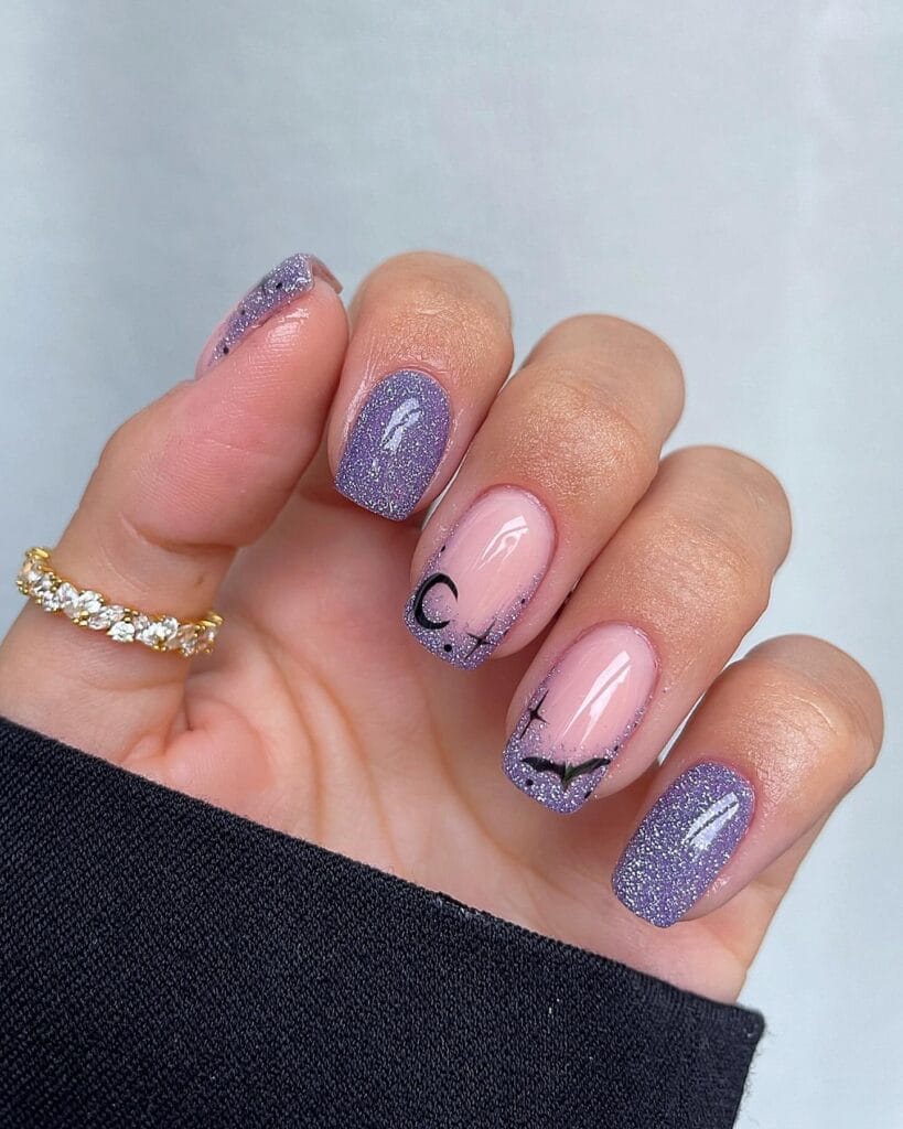 Lavender sparkle Halloween nails with bats, crescent moon, and ombré effect.