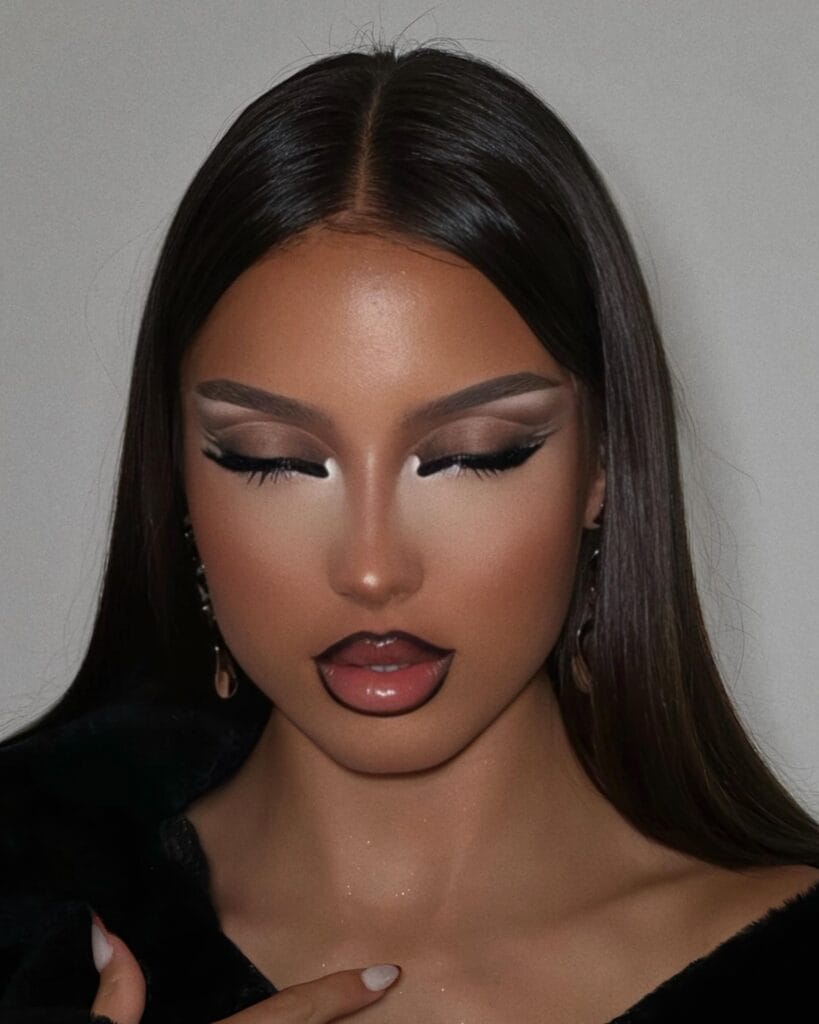 Bratz doll-inspired Halloween makeup with dramatic cut crease and glossy outlined lips.