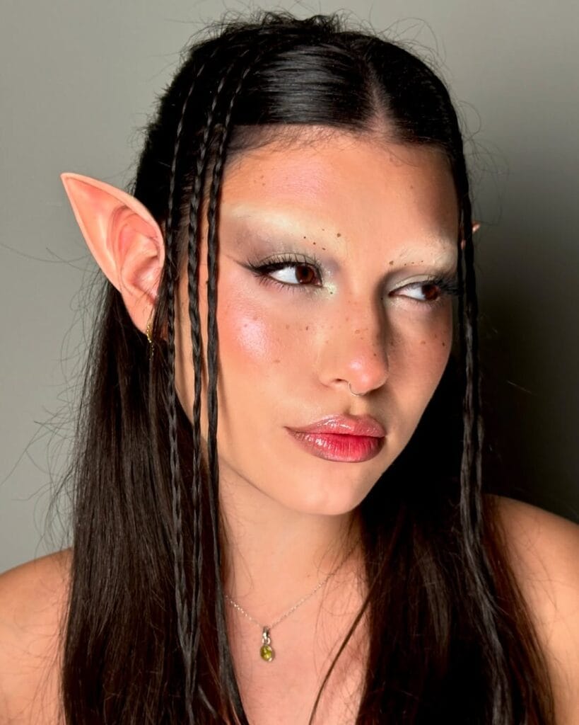 Woodland elf Halloween makeup with pointed ears and shimmery highlights.