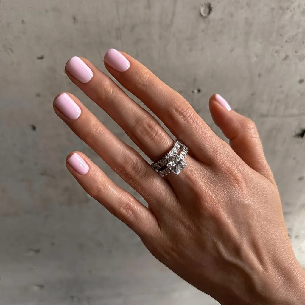 Light pink old money nails with glossy finish, styled with diamond rings, elegant and minimal manicure.