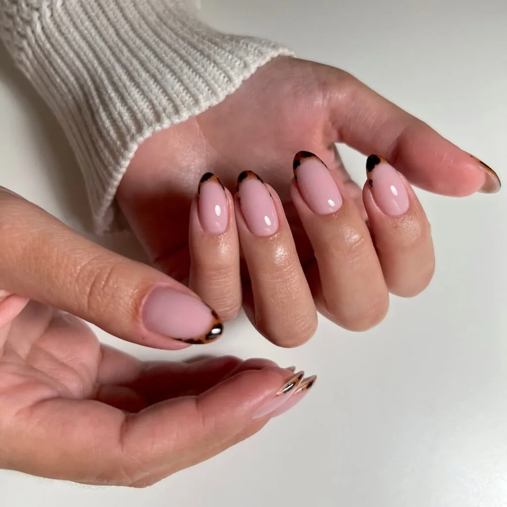 Old money nails with tortoiseshell French tips on pink base, modern and playful manicure.