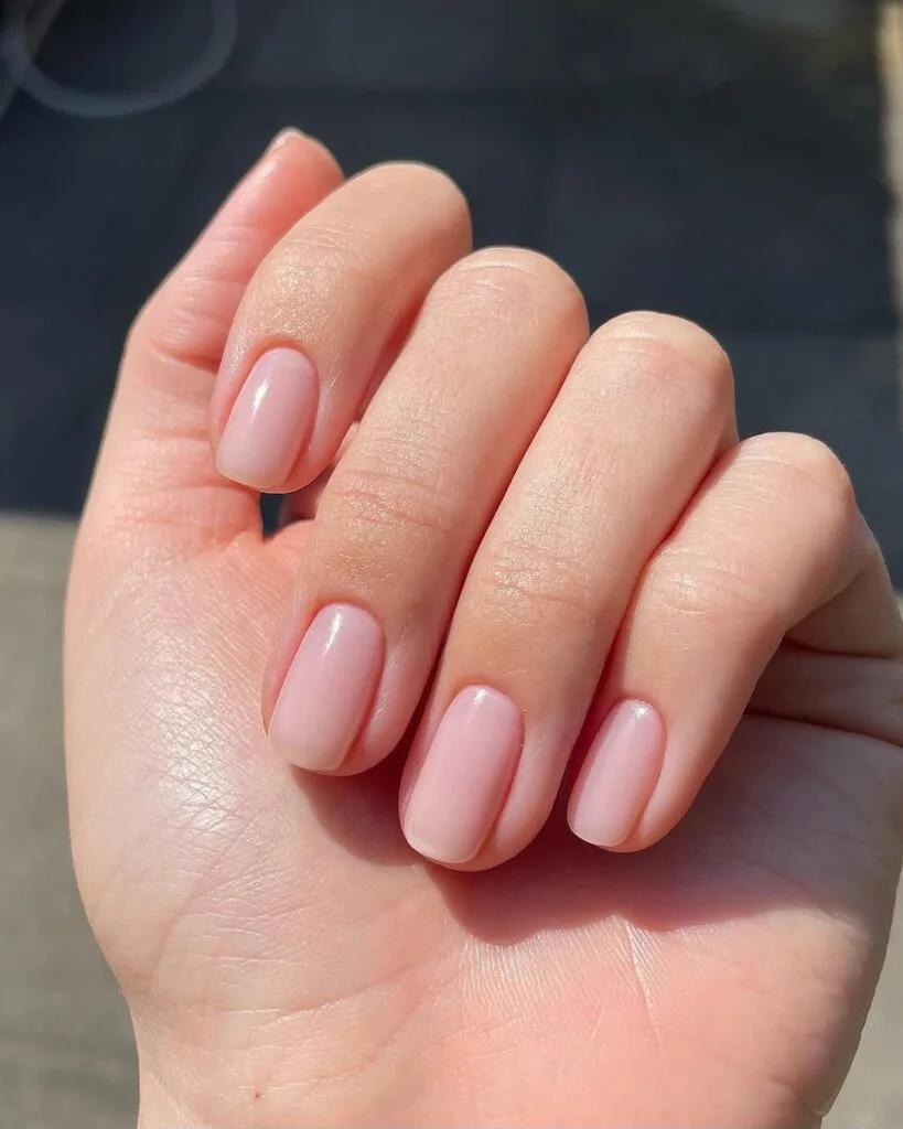 Short natural soft pink neutral nails, squoval shape, subtle and clean look.