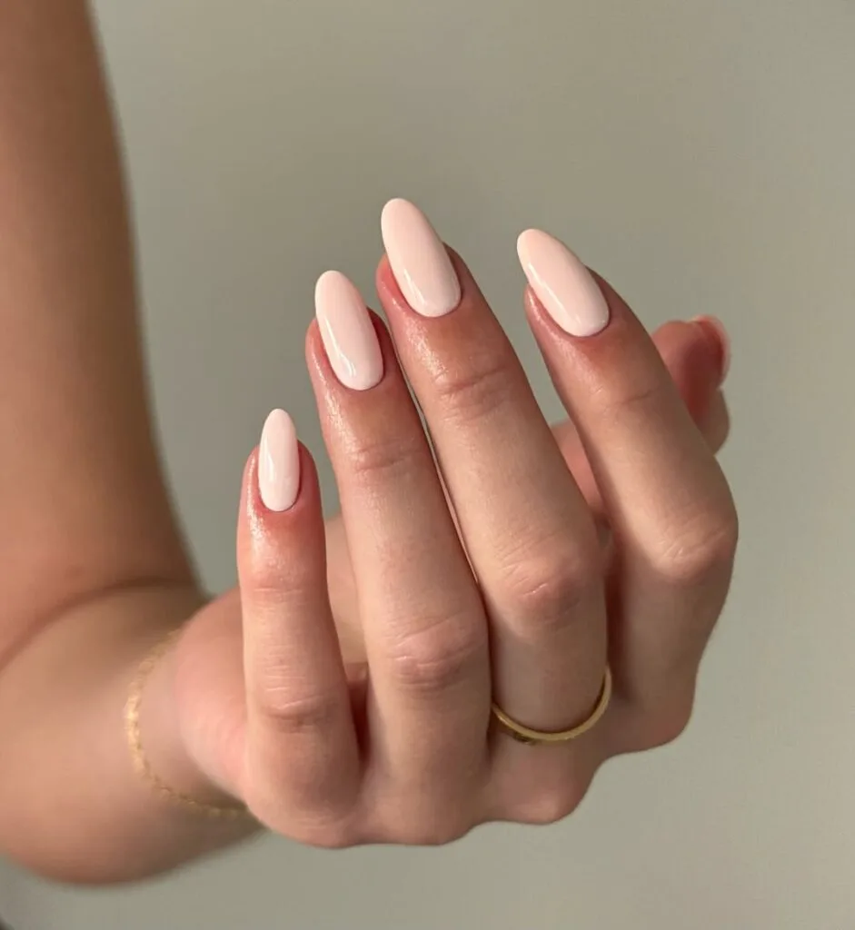 Creamy blush nude neutral nails, almond shape, glossy, elegant, and versatile.
