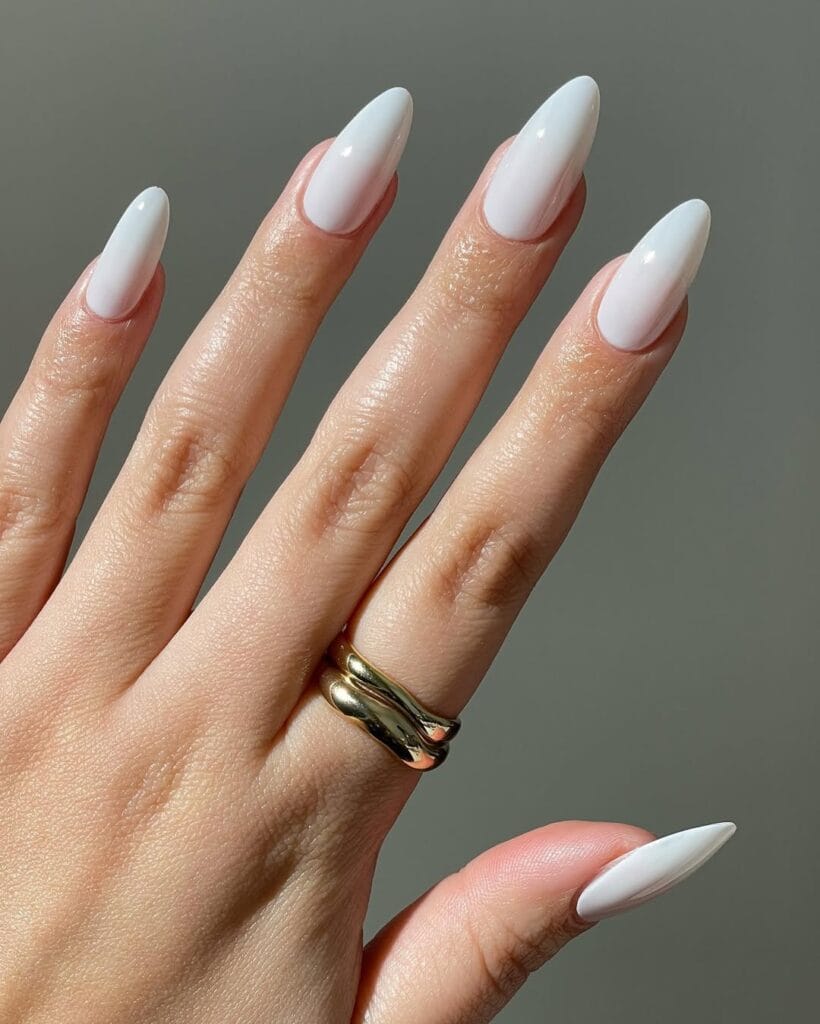  White almond neutral nails, high-gloss finish, sleek and elongated for a fresh look.
