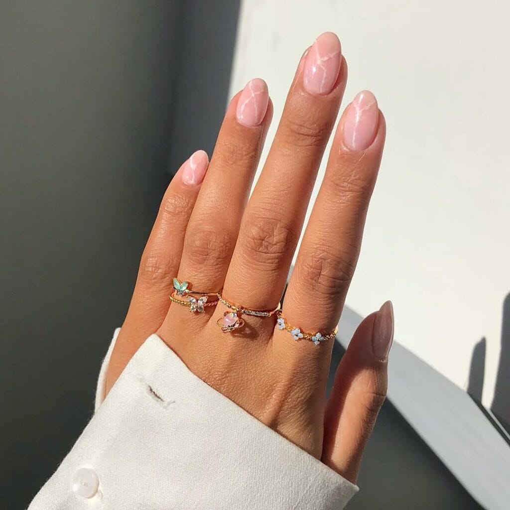 Milky pink marble old money nails with delicate swirls, elegant and light-catching, sophisticated manicure.
