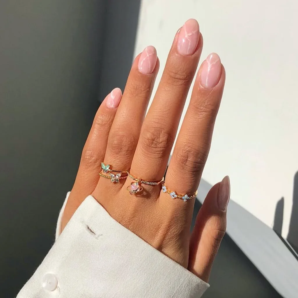 Milky pink marble old money nails with delicate swirls, elegant and light-catching, sophisticated manicure.