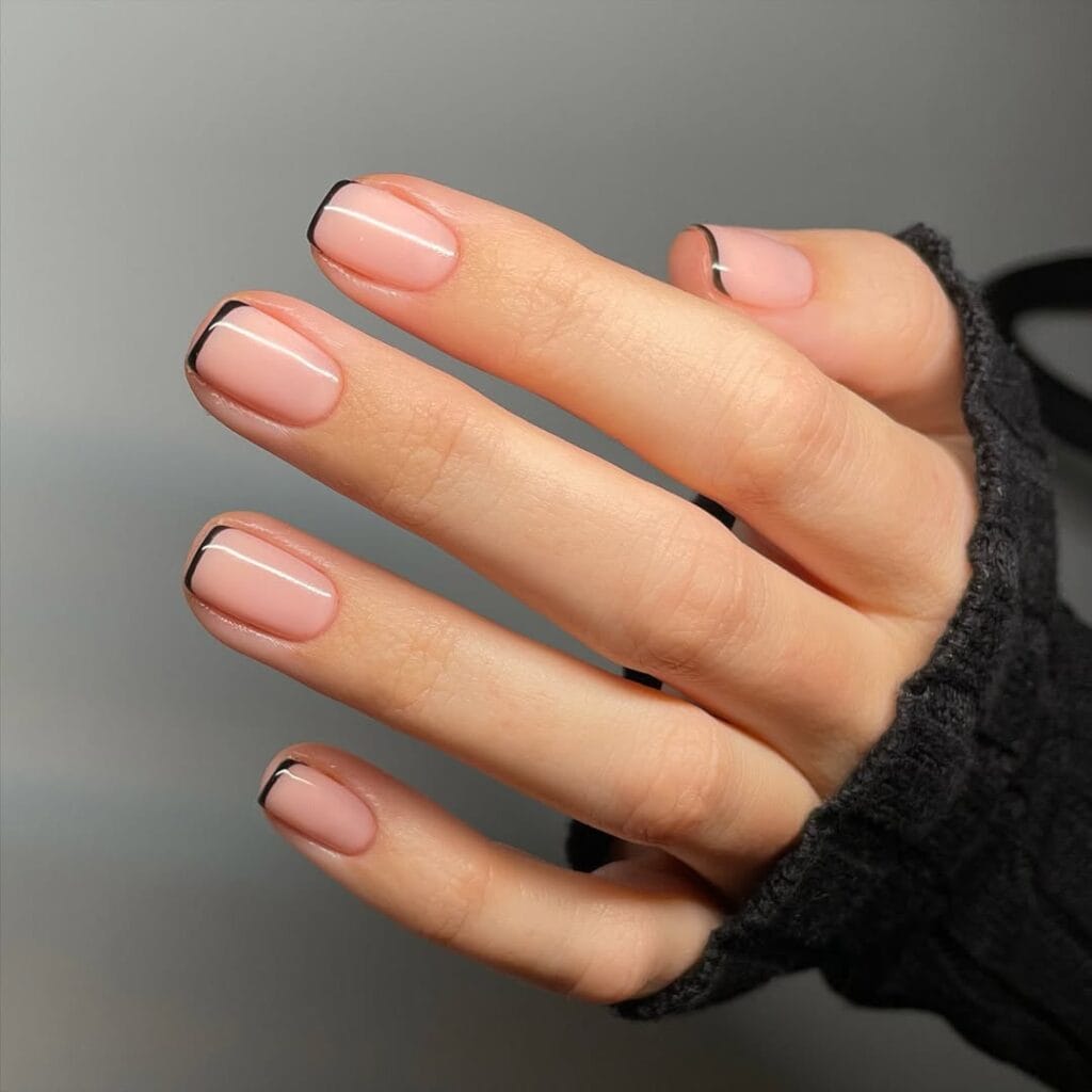 Old money nails with black French tip on nude base, minimal and modern, understated luxury.

